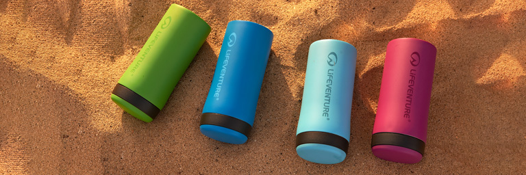 Lifeventure water bottles displayed on a beach